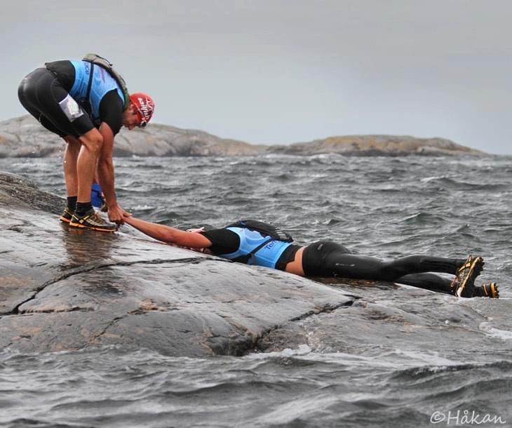 One hand reaching for another in challenging water — collaboration
